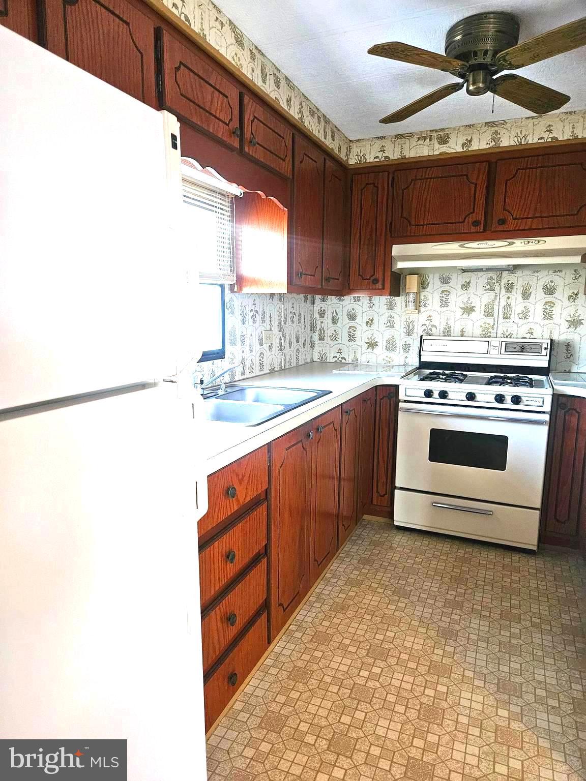 568 Miles Standish Lane Buena, NJ 08310 - Photo 10 of 19 a kitchen with stainless steel appliances a stove a sink and a refrigerator