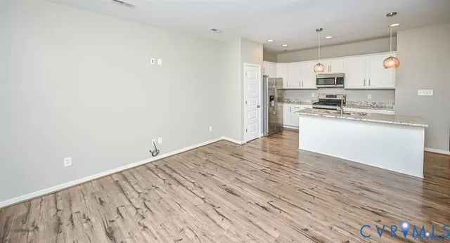 a kitchen with stainless steel appliances a refrigerator and a stove top oven