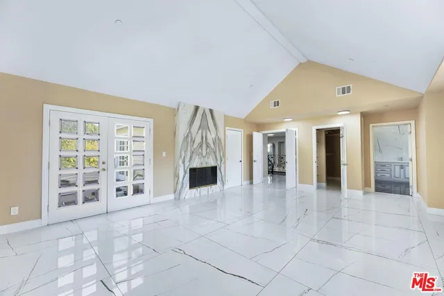a spacious bathroom with a granite countertop sink mirror and bathtub