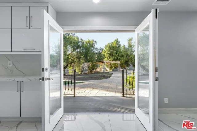 a view of a living room and balcony