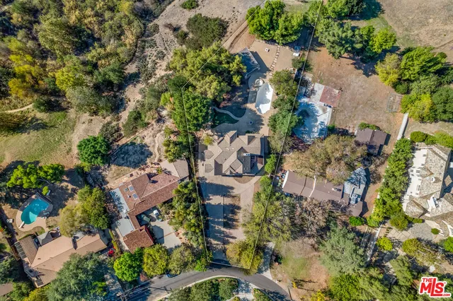 an aerial view of a house with a yard and garden
