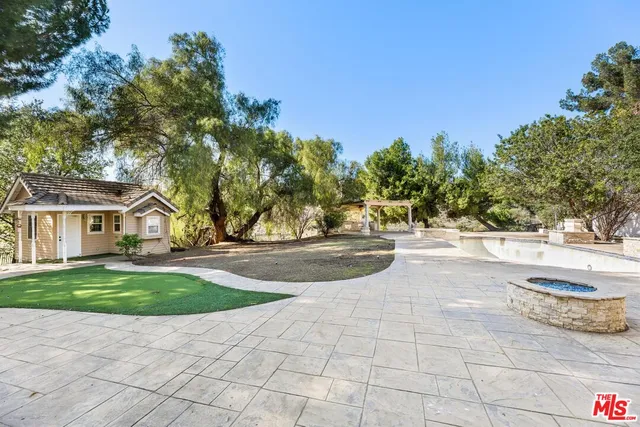 a front view of a building with trees