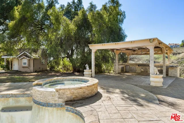 a view of a white house with a swimming pool
