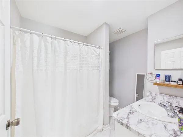 a bedroom with a bed and a curtain