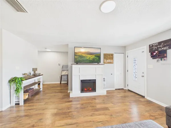 an empty room with furniture and a fireplace