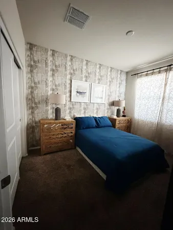 a bedroom with a bed and a window