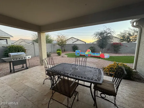 a view of an outdoor dining space with furniture and outdoor view