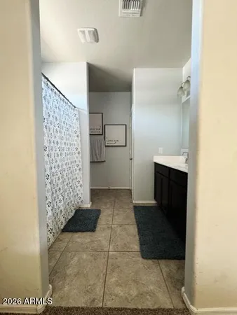 a bathroom with a shower and a sink