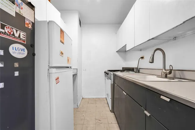 a kitchen with a sink and refrigerator