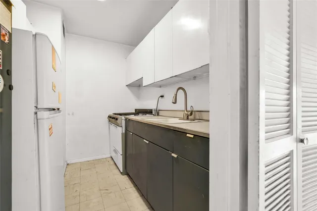 a kitchen with a sink and a refrigerator