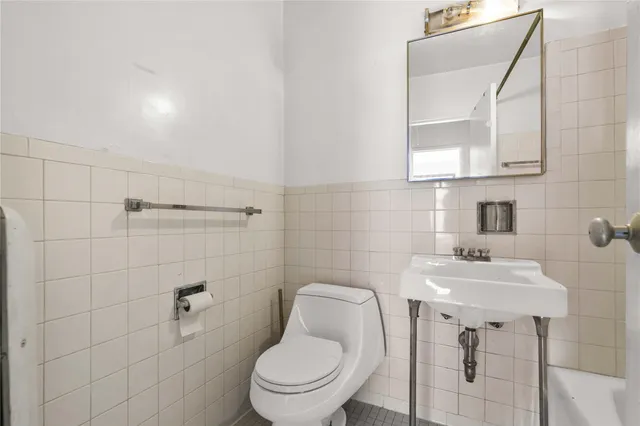 a bathroom with a sink a toilet and bathtub