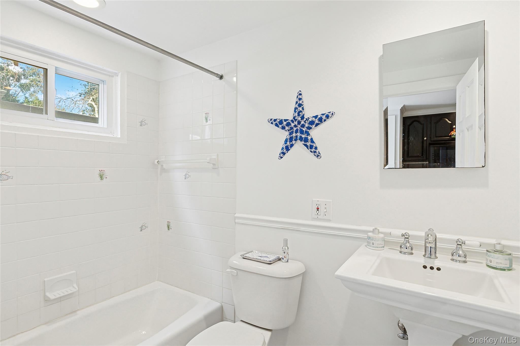 150 Hobart Road Southold, NY 11971 - Photo 8 of 18 a bathroom with a toilet sink and mirror