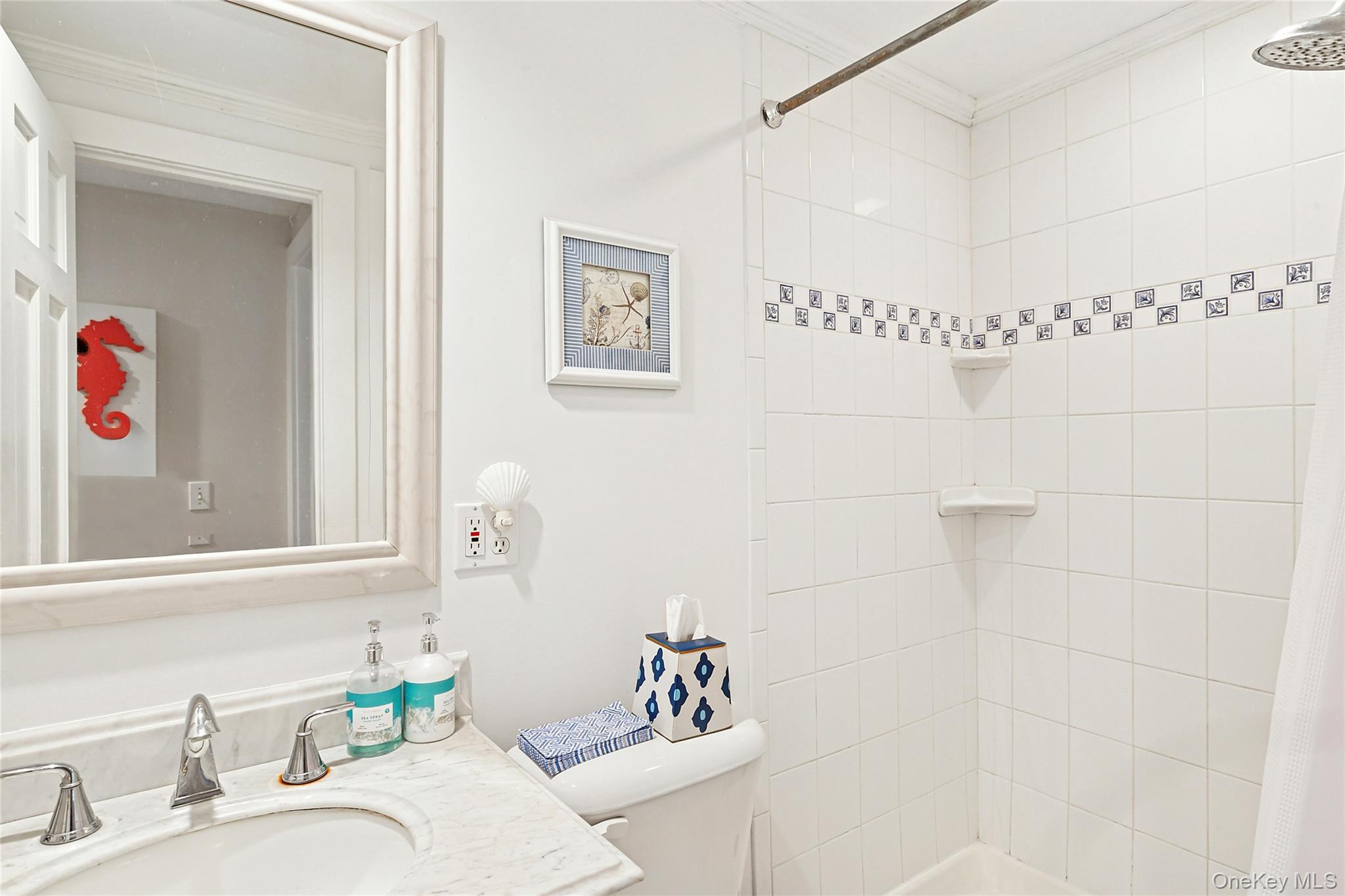 150 Hobart Road Southold, NY 11971 - Photo 9 of 18 a bathroom with a granite countertop sink a mirror and a shower