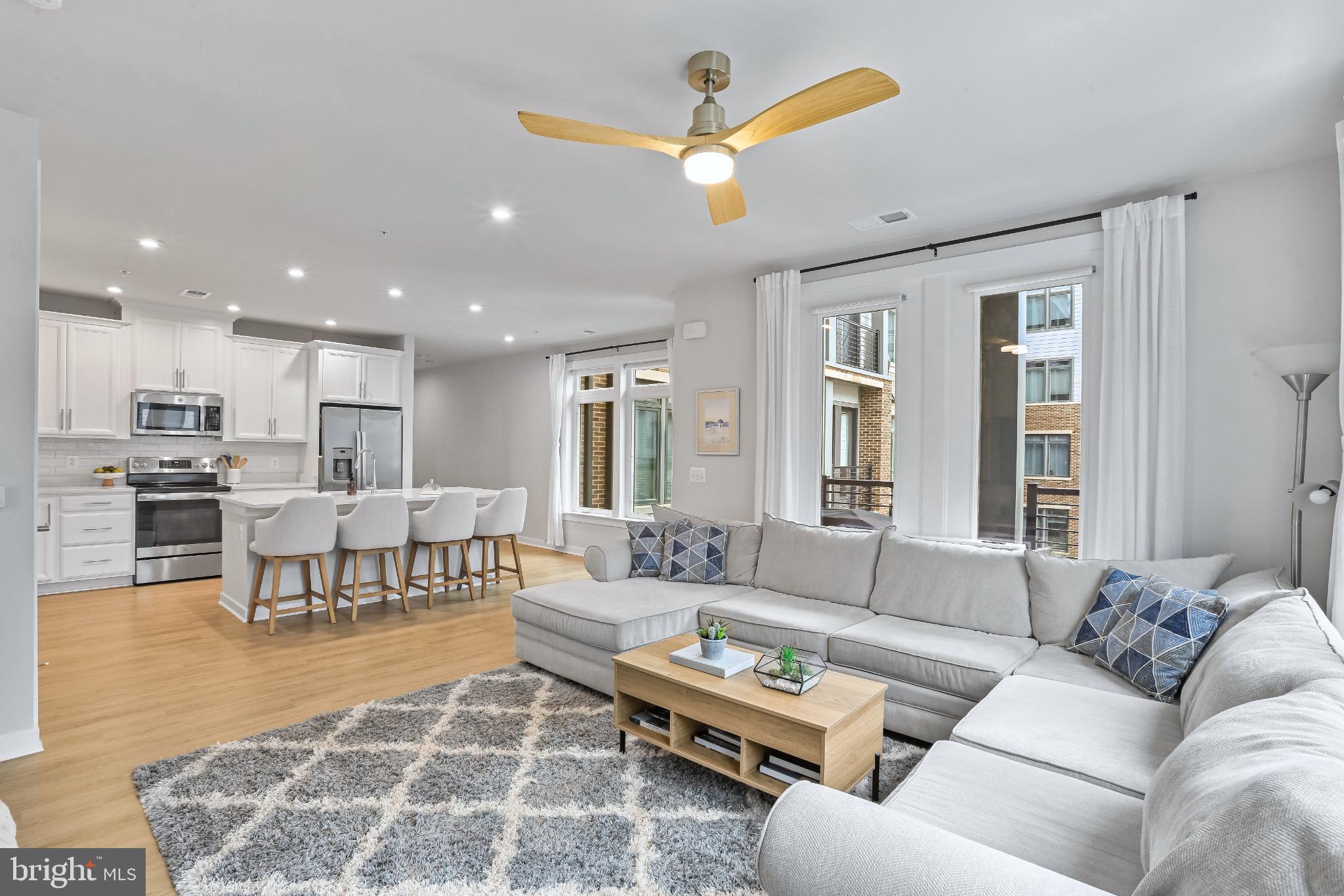 1675 Bandit Loop, Unit 201B Reston, VA 20190 - Photo 1 of 27 a living room with furniture kitchen view and a chandelier