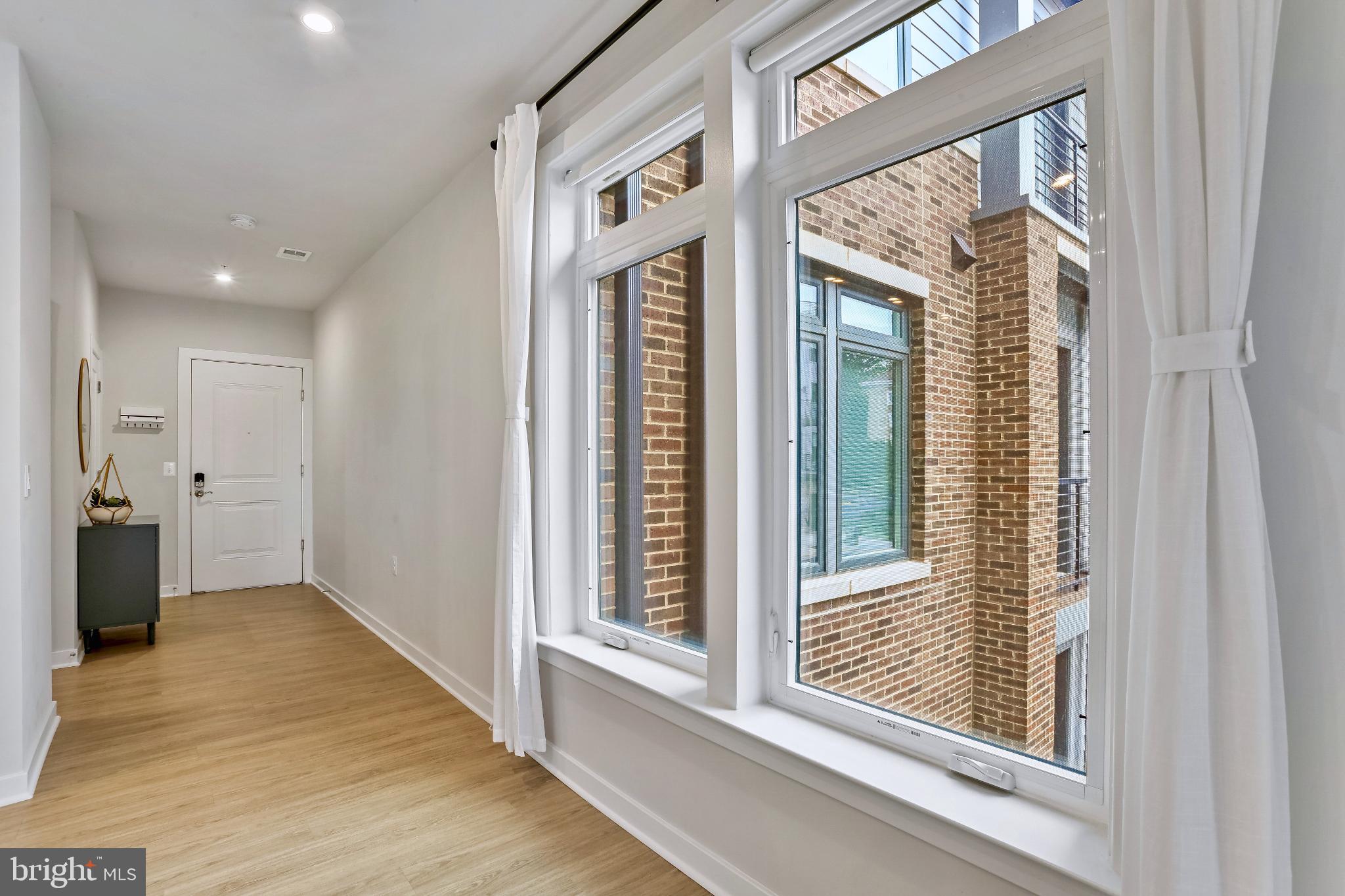 1675 Bandit Loop, Unit 201B Reston, VA 20190 - Photo 11 of 27 a view of a room that has a large window