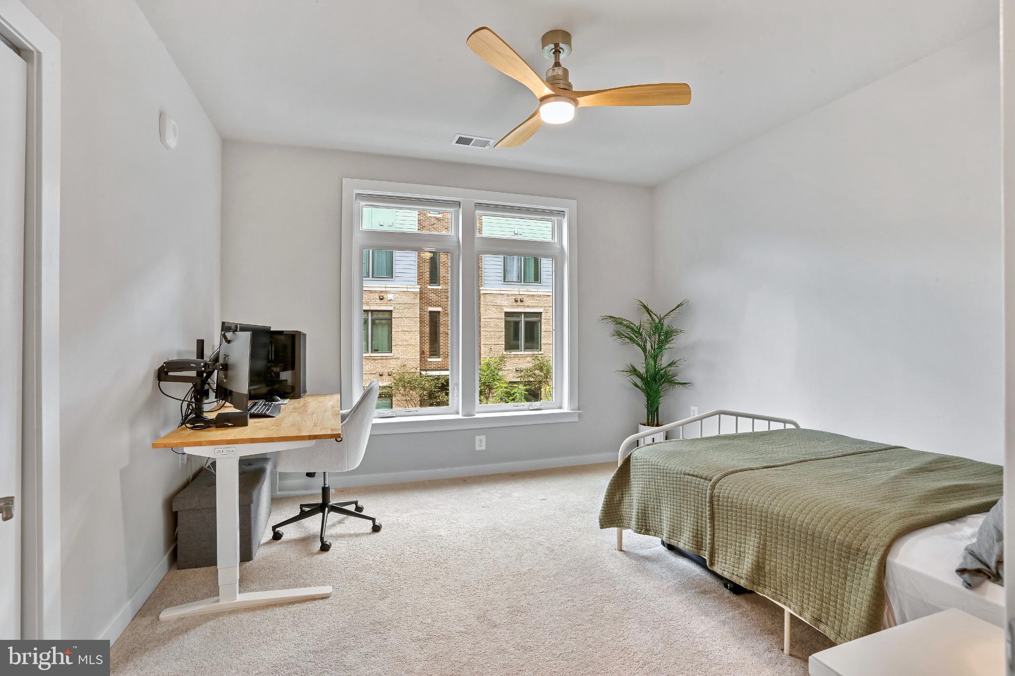 1675 Bandit Loop, Unit 201B Reston, VA 20190 - Photo 13 of 27 a bedroom that has a bed and a desk in it