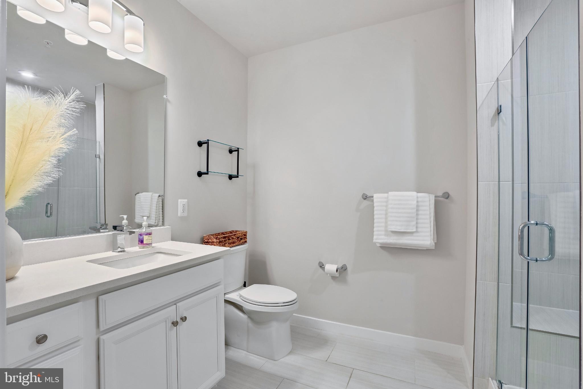 1675 Bandit Loop, Unit 201B Reston, VA 20190 - Photo 14 of 27 a bathroom with a toilet sink vanity and mirror