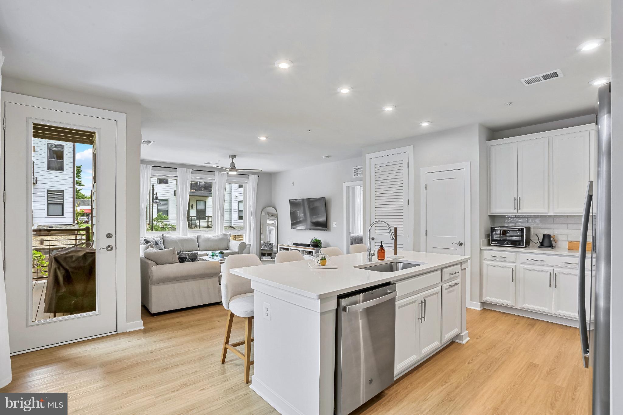 1675 Bandit Loop, Unit 201B Reston, VA 20190 - Photo 2 of 27 a kitchen that has a lot of cabinets in it and wooden floors