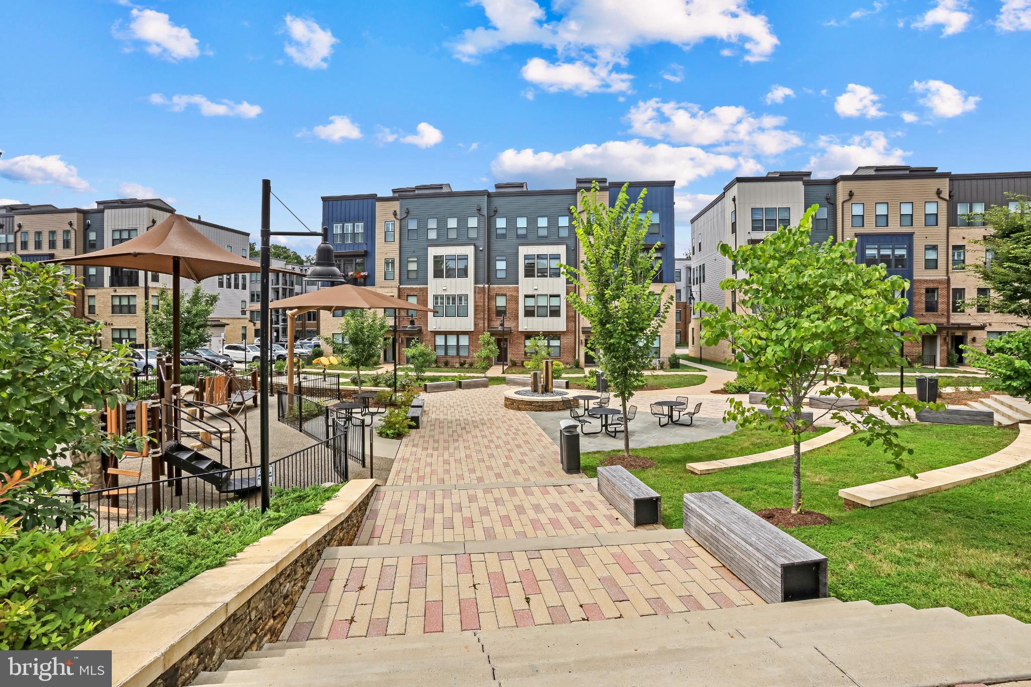 1675 Bandit Loop, Unit 201B Reston, VA 20190 - Photo 26 of 27 a view of a swimming pool with a patio and plants