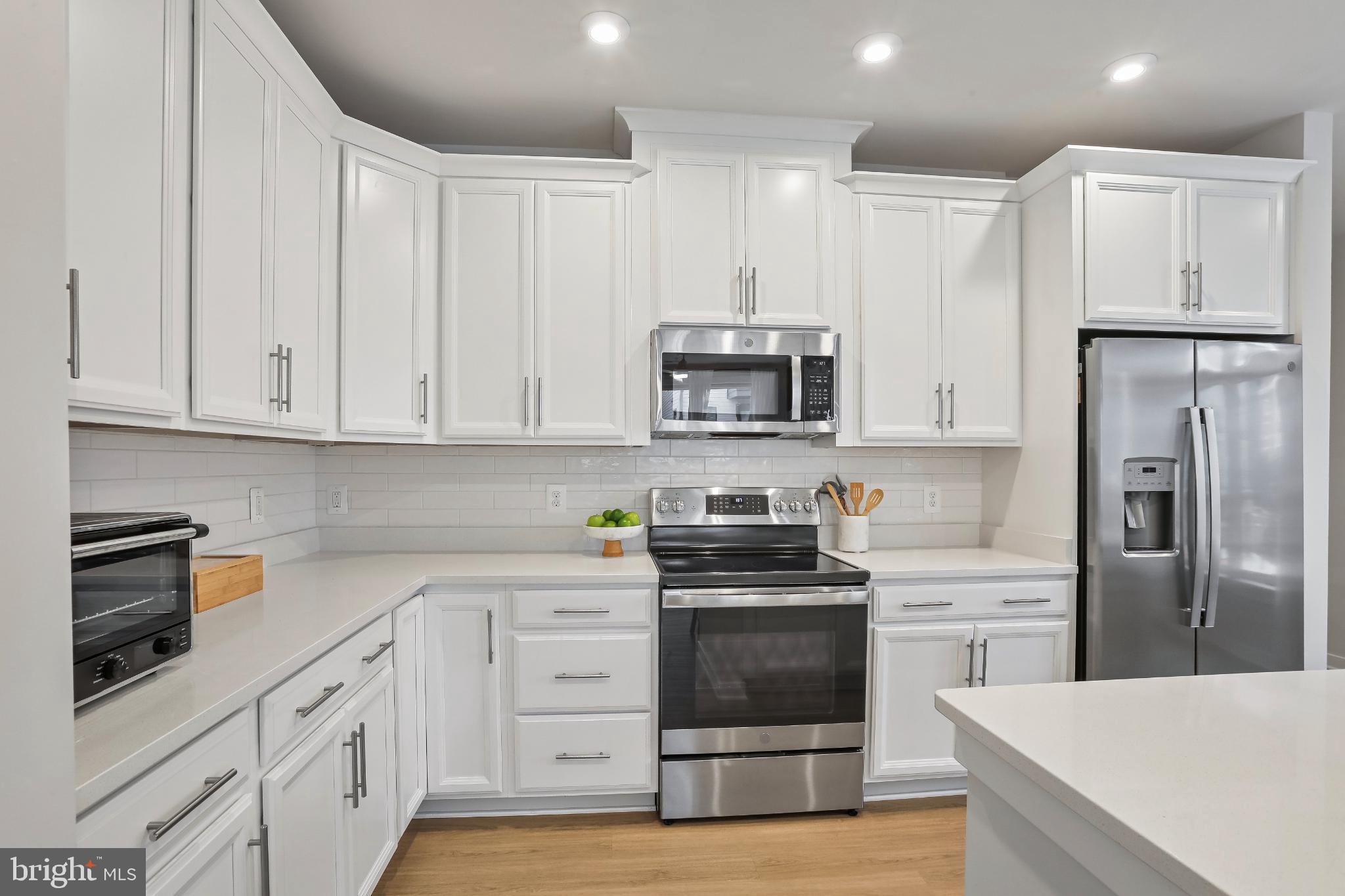 1675 Bandit Loop, Unit 201B Reston, VA 20190 - Photo 4 of 27 a kitchen with white cabinets and stainless steel appliances