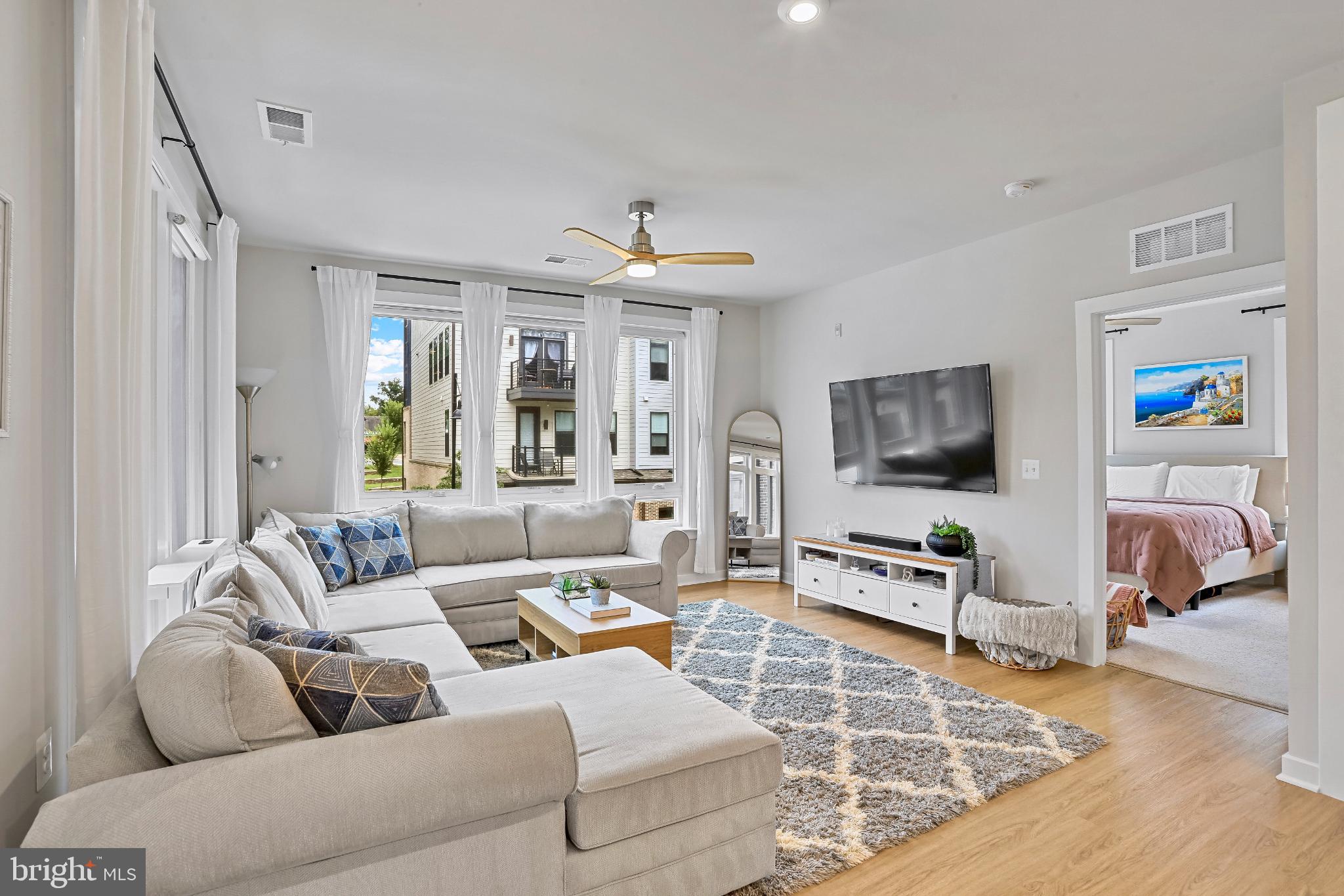 1675 Bandit Loop, Unit 201B Reston, VA 20190 - Photo 6 of 27 a living room with furniture and a flat screen tv