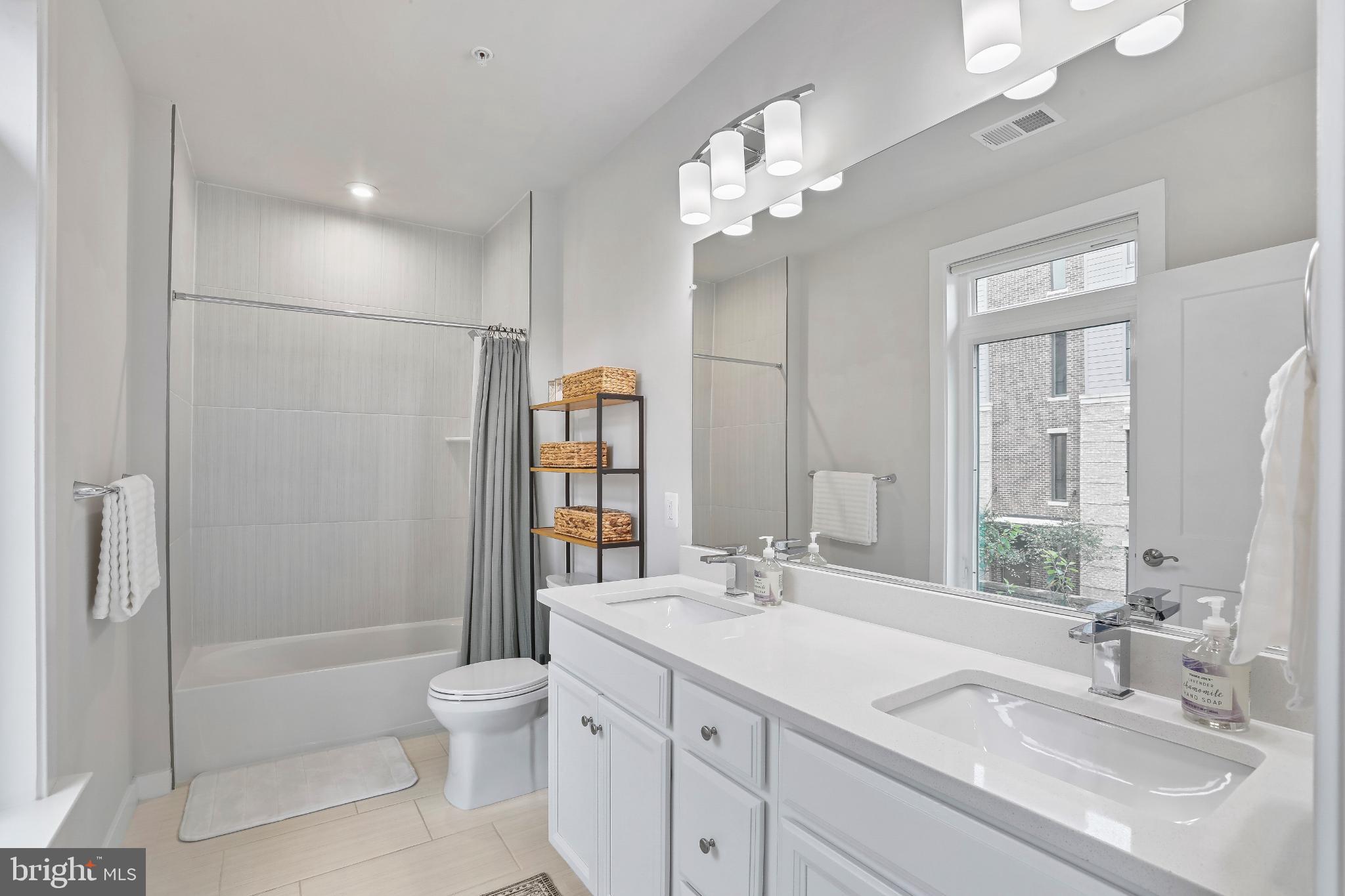 1675 Bandit Loop, Unit 201B Reston, VA 20190 - Photo 9 of 27 a bathroom with a sink a toilet and shower