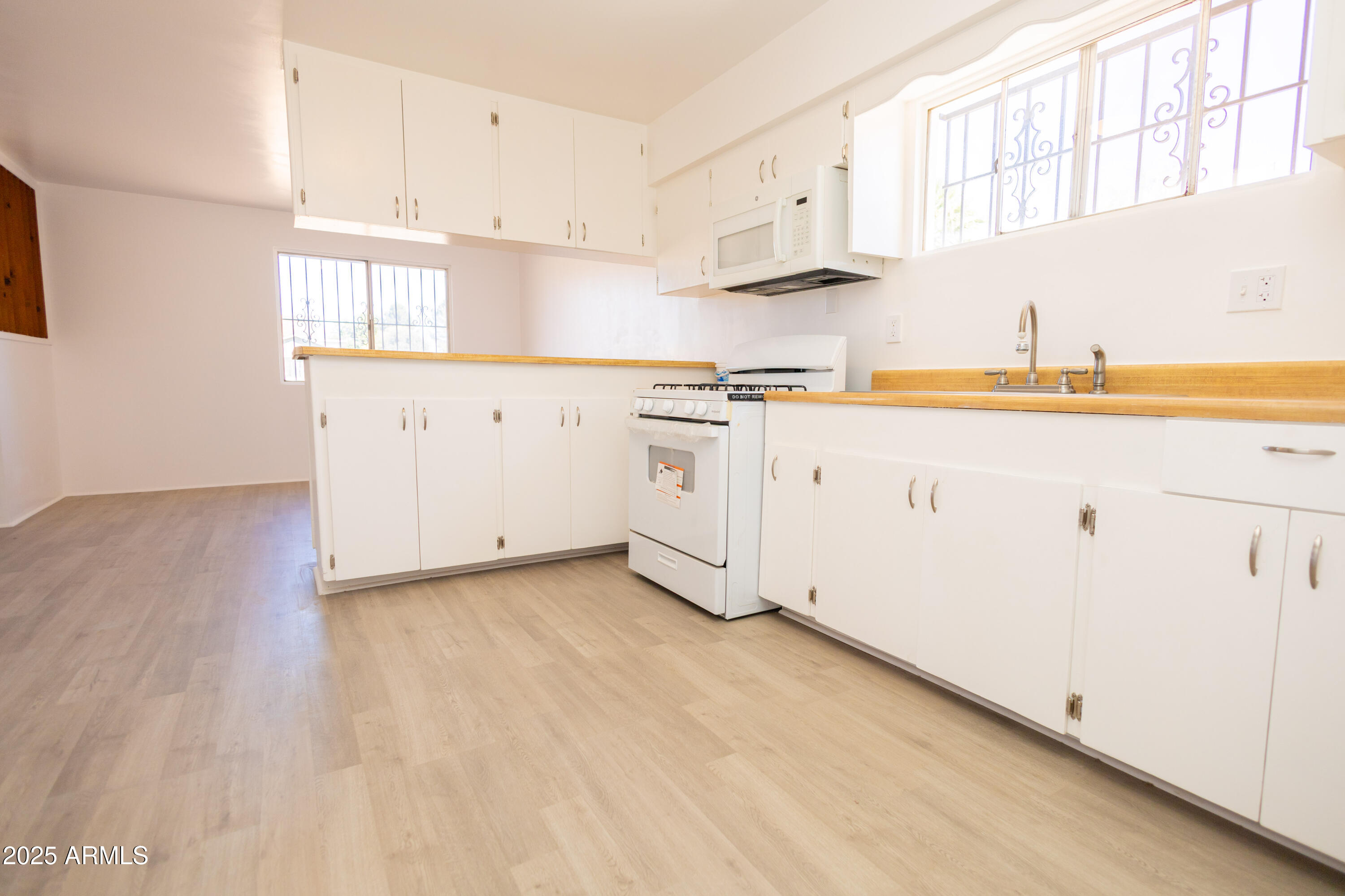 1301 East 14th Street Douglas, AZ 85607 - Photo 22 of 45 a kitchen with cabinets appliances a sink and a window