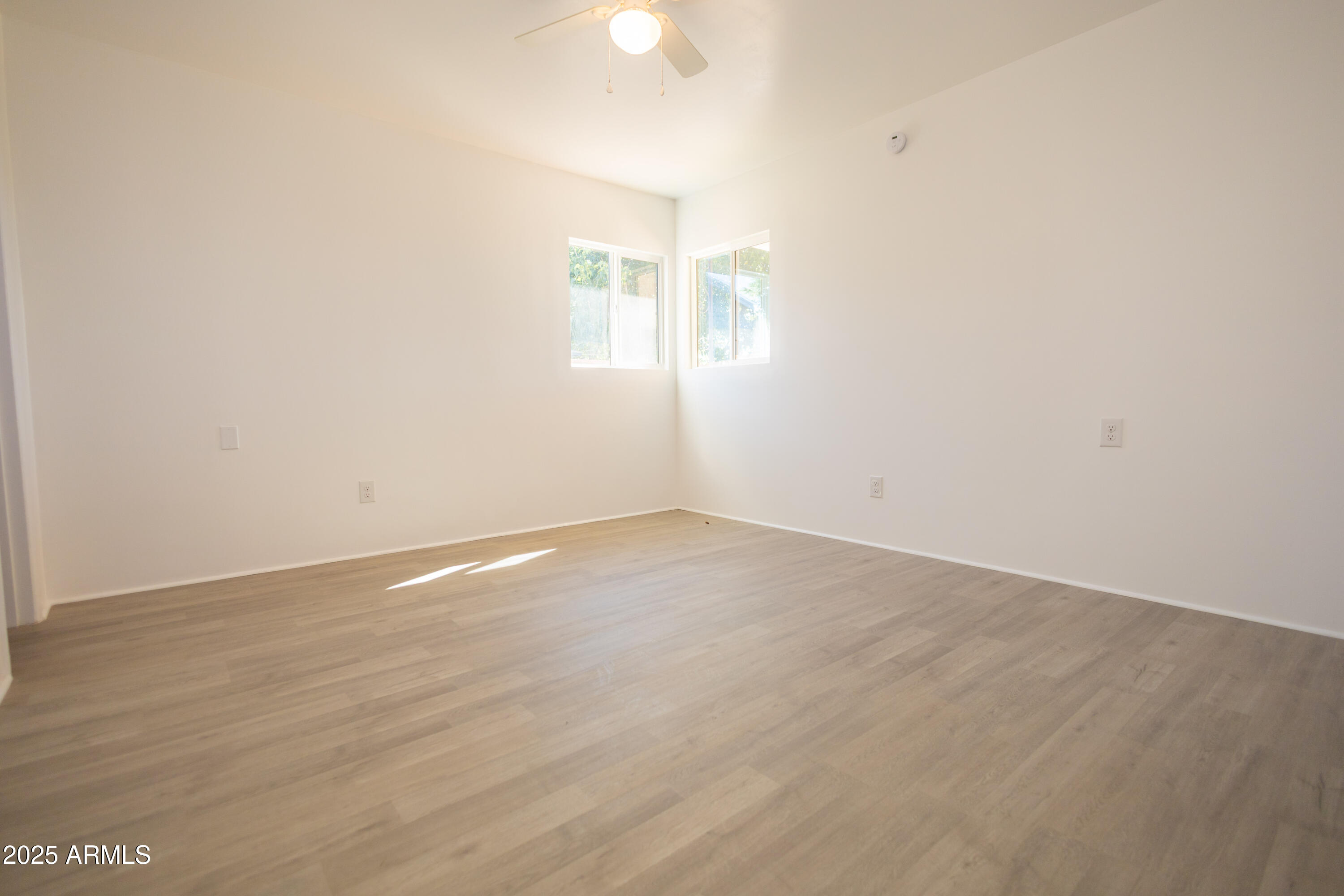 1301 East 14th Street Douglas, AZ 85607 - Photo 31 of 45 an empty room with wooden floor and windows
