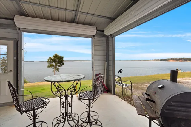 a balcony with table and chairs