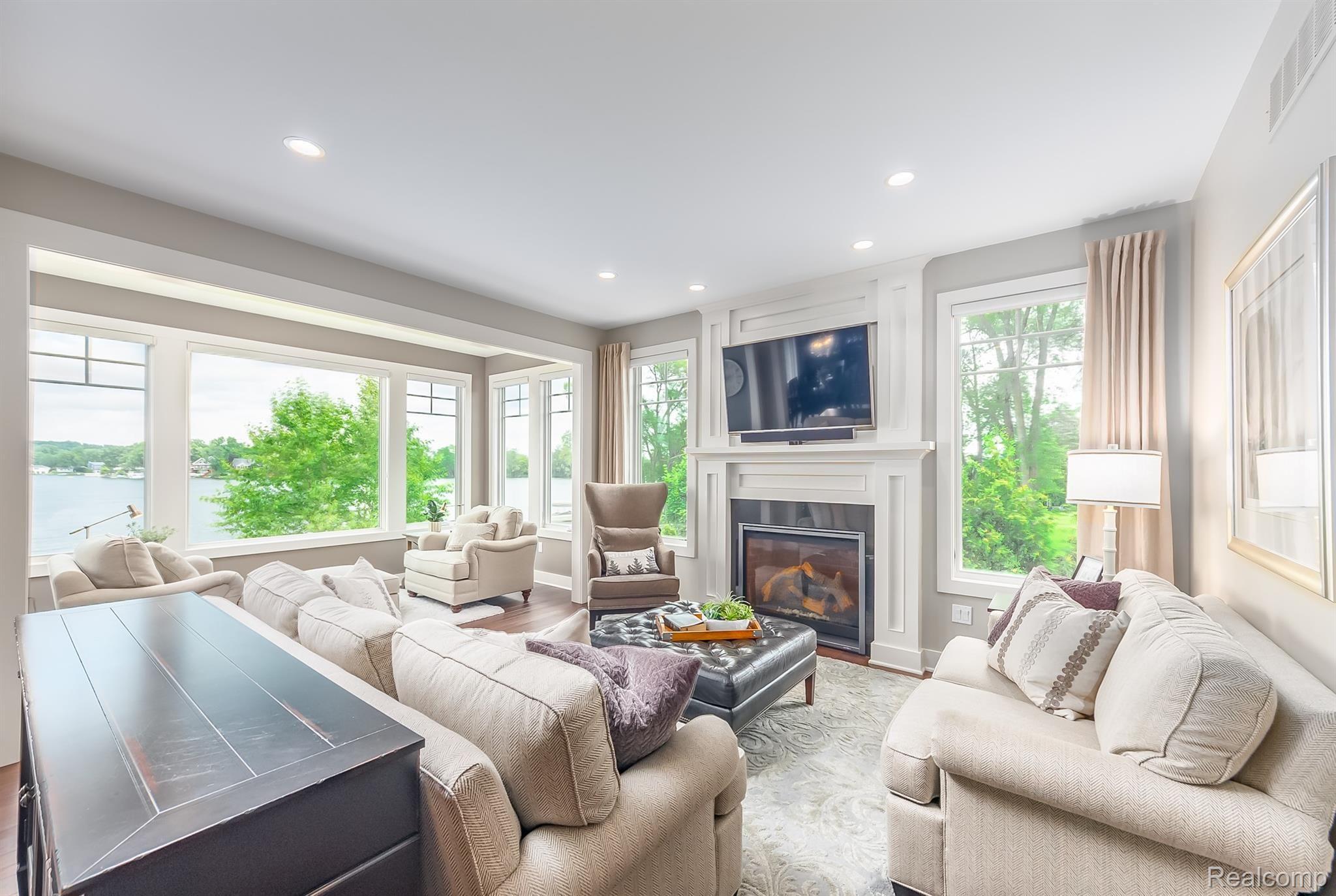 8309 Hilton Road Brighton, MI 48114 - Photo 13 of 56 Great room with a gas fireplace and lots of natural light