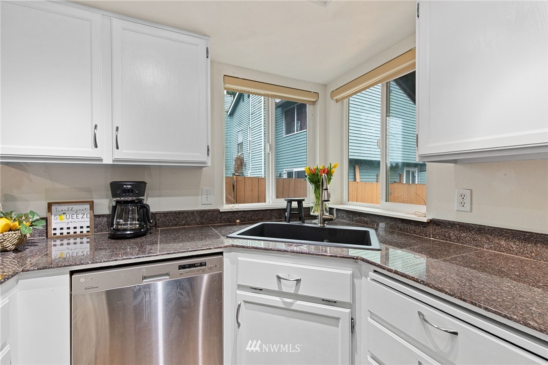 18505 20th Drive Southeast Bothell, WA 98012 - Photo 11 of 35 a kitchen with appliances a sink and cabinets