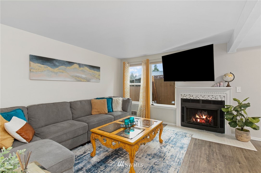 18505 20th Drive Southeast Bothell, WA 98012 - Photo 2 of 35 a living room with furniture a flat screen tv and a fireplace