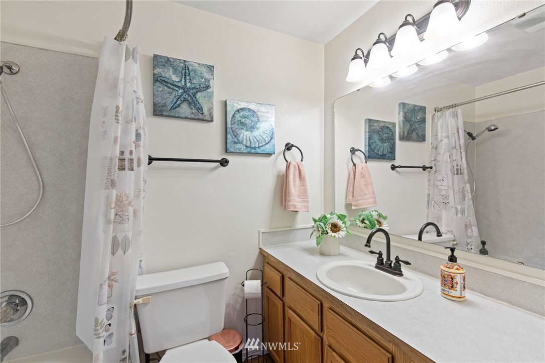 18505 20th Drive Southeast Bothell, WA 98012 - Photo 27 of 35 a bathroom with a granite countertop sink mirror vanity and toilet