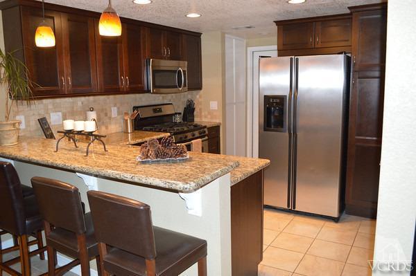 1934 Rory Lane, Unit 4 Simi Valley, CA 93063 - Photo 1 of 15 a kitchen with stainless steel appliances granite countertop a refrigerator a stove a sink and a microwave