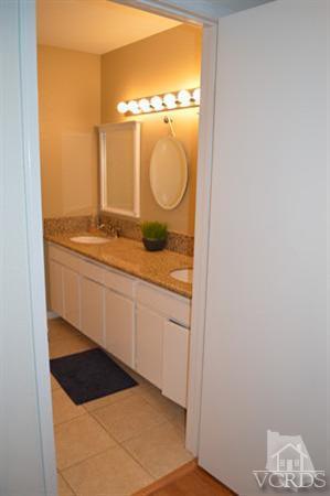 1934 Rory Lane, Unit 4 Simi Valley, CA 93063 - Photo 11 of 15 a bathroom with a granite countertop sink and a mirror