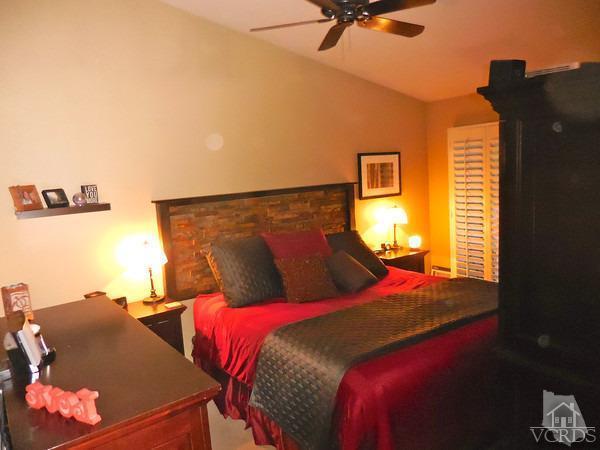 1934 Rory Lane, Unit 4 Simi Valley, CA 93063 - Photo 4 of 15 a bed sitting in a bedroom next to a window with a lamp