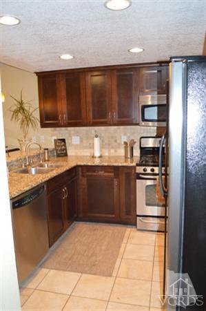 1934 Rory Lane, Unit 4 Simi Valley, CA 93063 - Photo 10 of 15 a kitchen with a sink a stove top oven and cabinets