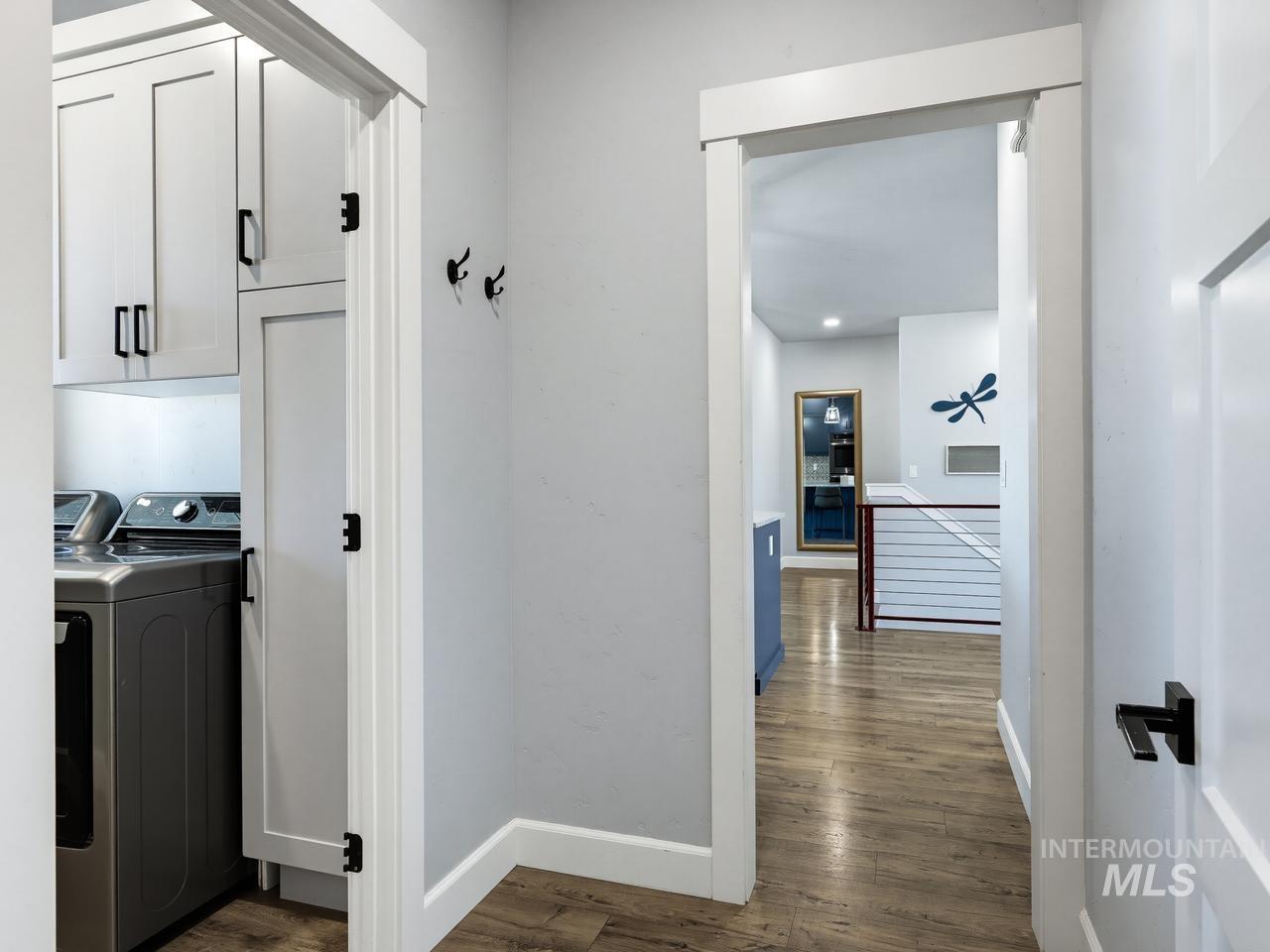 4950 West Columbia Road Nampa, ID 83687 - Photo 29 of 50 Dedicated laundry area featuring built-in cabinetry, modern appliances, and wood-finish flooring