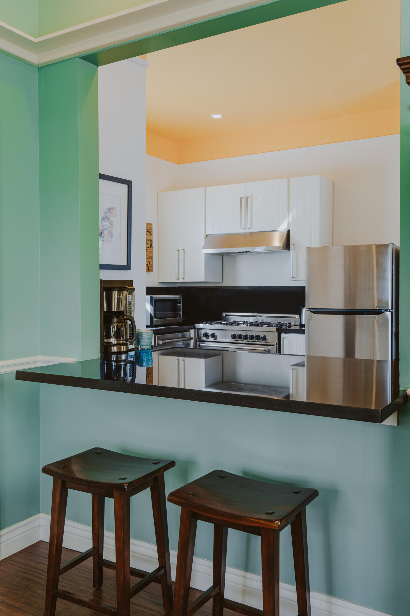 502 Brinkerhoff Avenue Santa Barbara, CA 93101 - Photo 11 of 34 a kitchen with stainless steel appliances kitchen island granite countertop a table chairs sink and cabinets