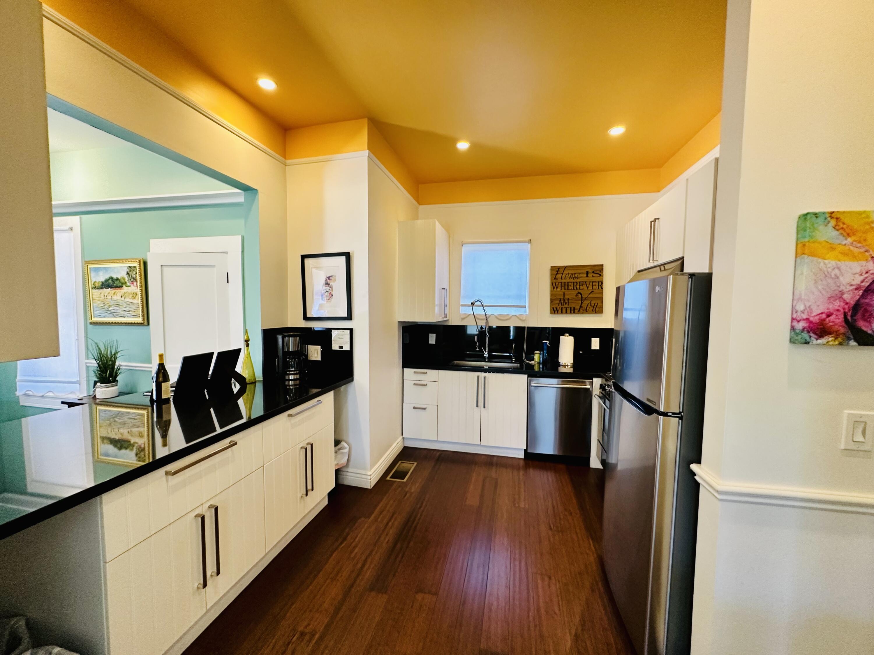 502 Brinkerhoff Avenue Santa Barbara, CA 93101 - Photo 15 of 34 a large kitchen with stainless steel appliances a refrigerator and a stove top oven