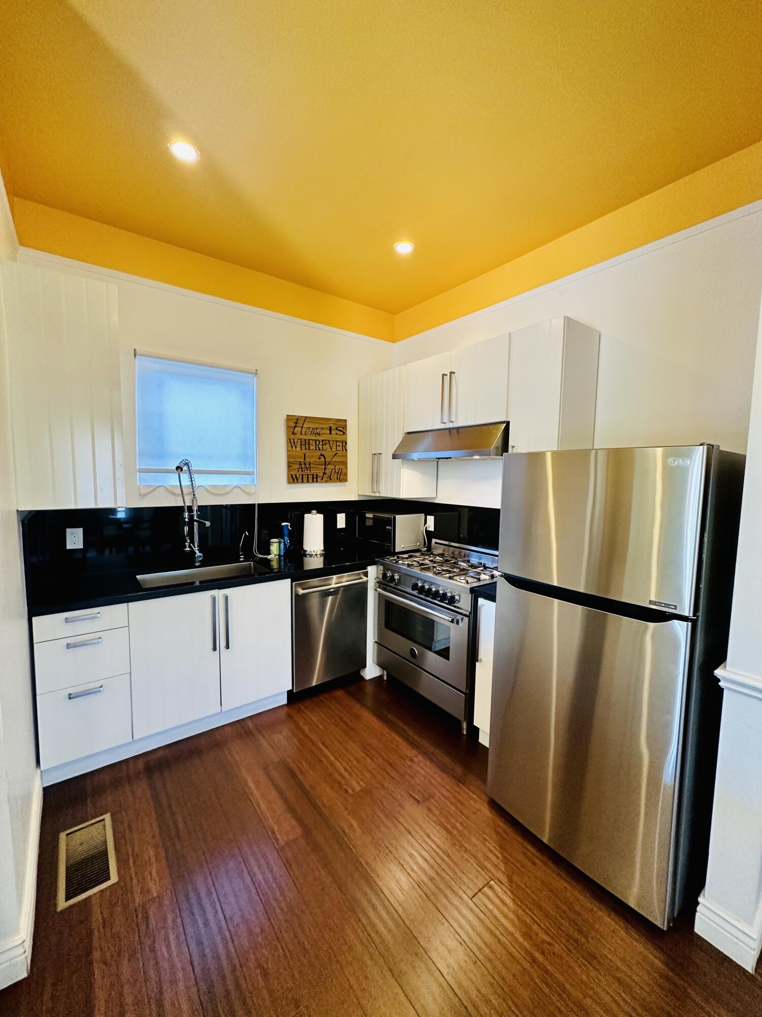 502 Brinkerhoff Avenue Santa Barbara, CA 93101 - Photo 16 of 34 a kitchen with stainless steel appliances a refrigerator sink and white cabinets