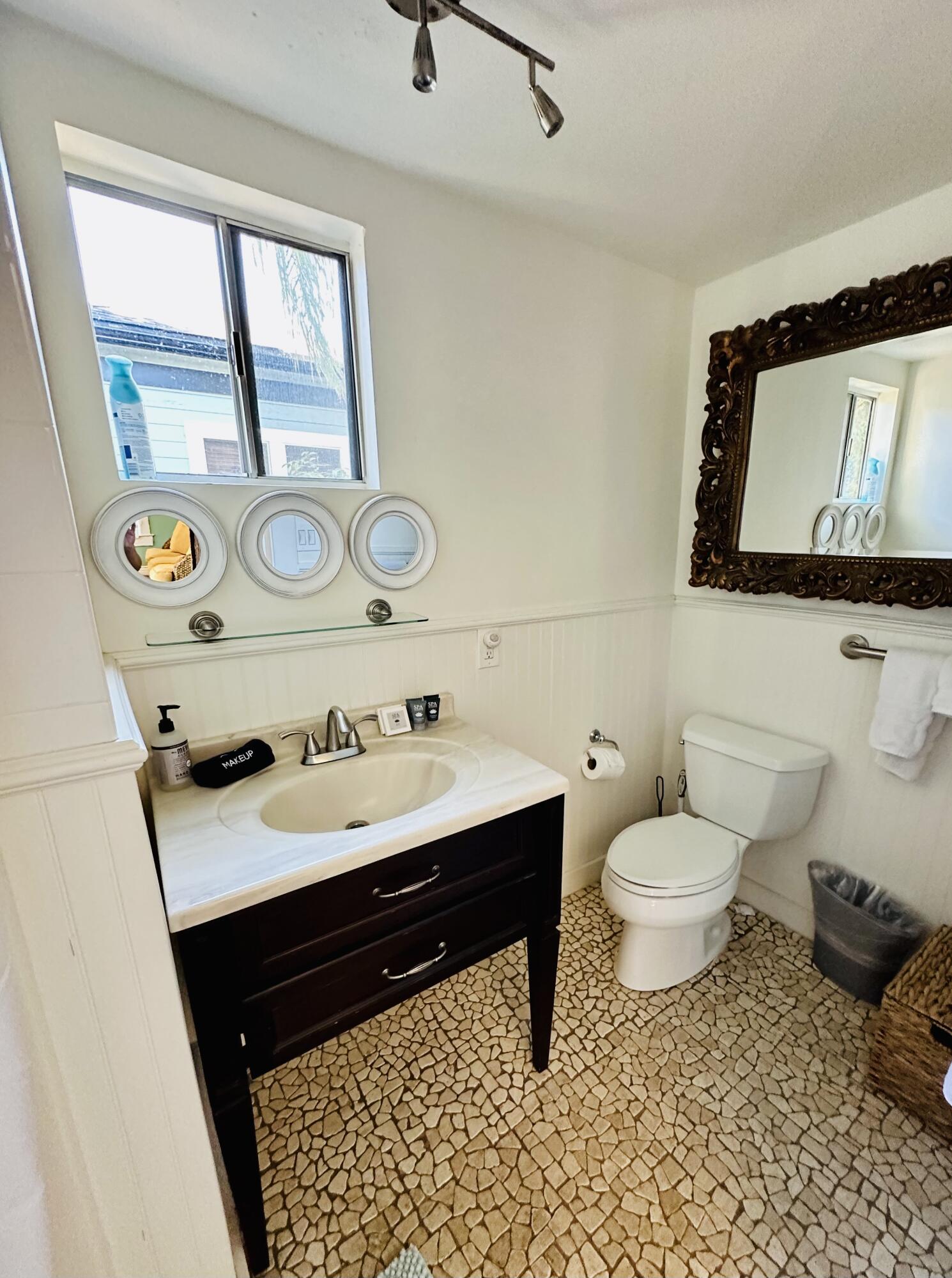 502 Brinkerhoff Avenue Santa Barbara, CA 93101 - Photo 24 of 34 a bathroom with a sink vanity mirror and toilet