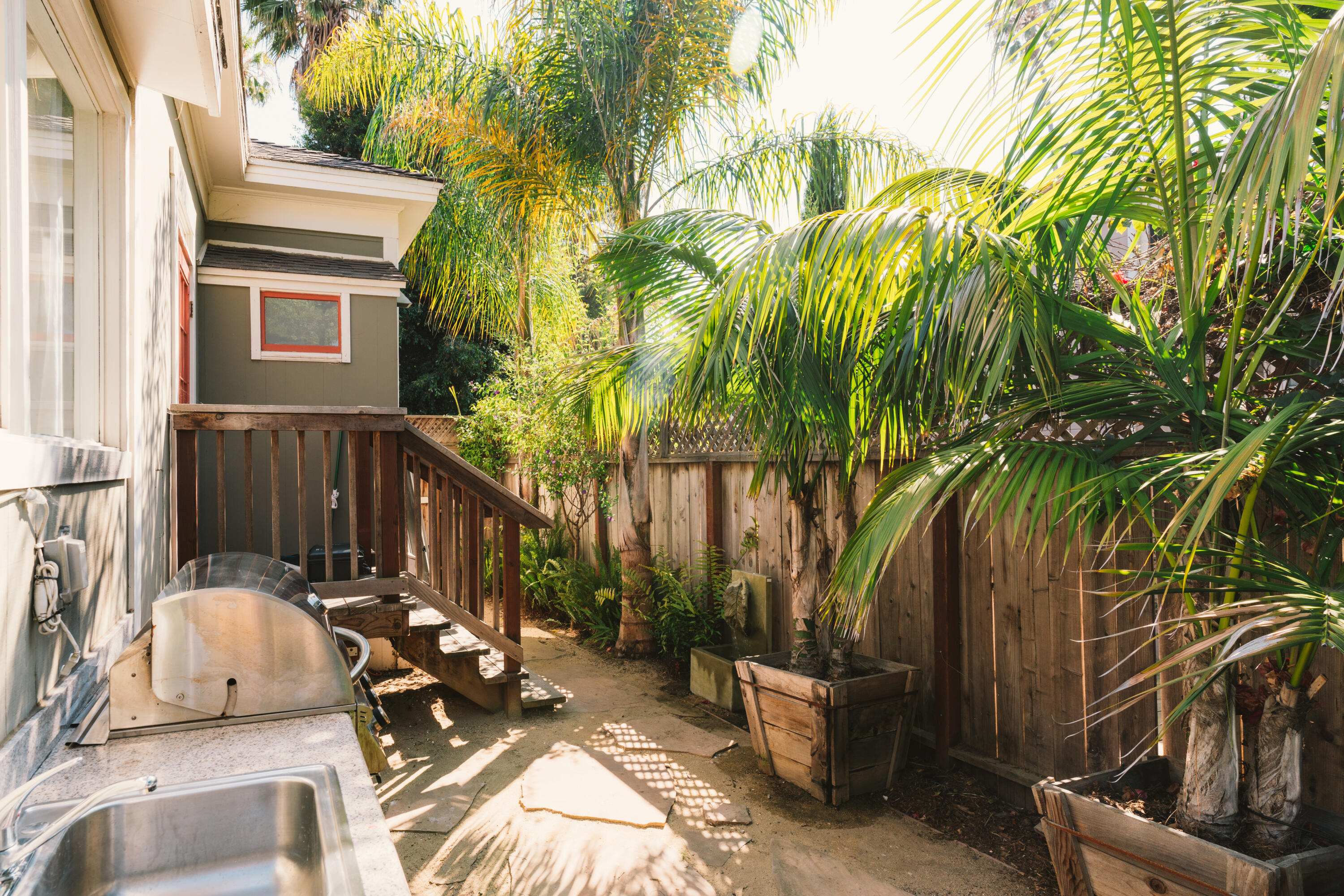 502 Brinkerhoff Avenue Santa Barbara, CA 93101 - Photo 29 of 34 a view of a patio with table and chairs potted plants and palm tree