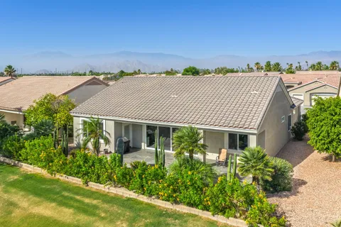 an aerial view of house with an outdoor space and seating