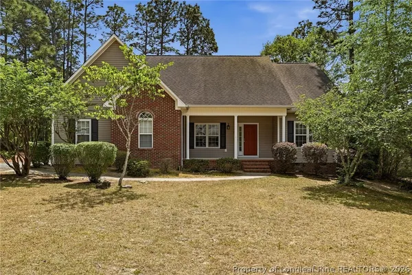 a house that has a tree in front of it