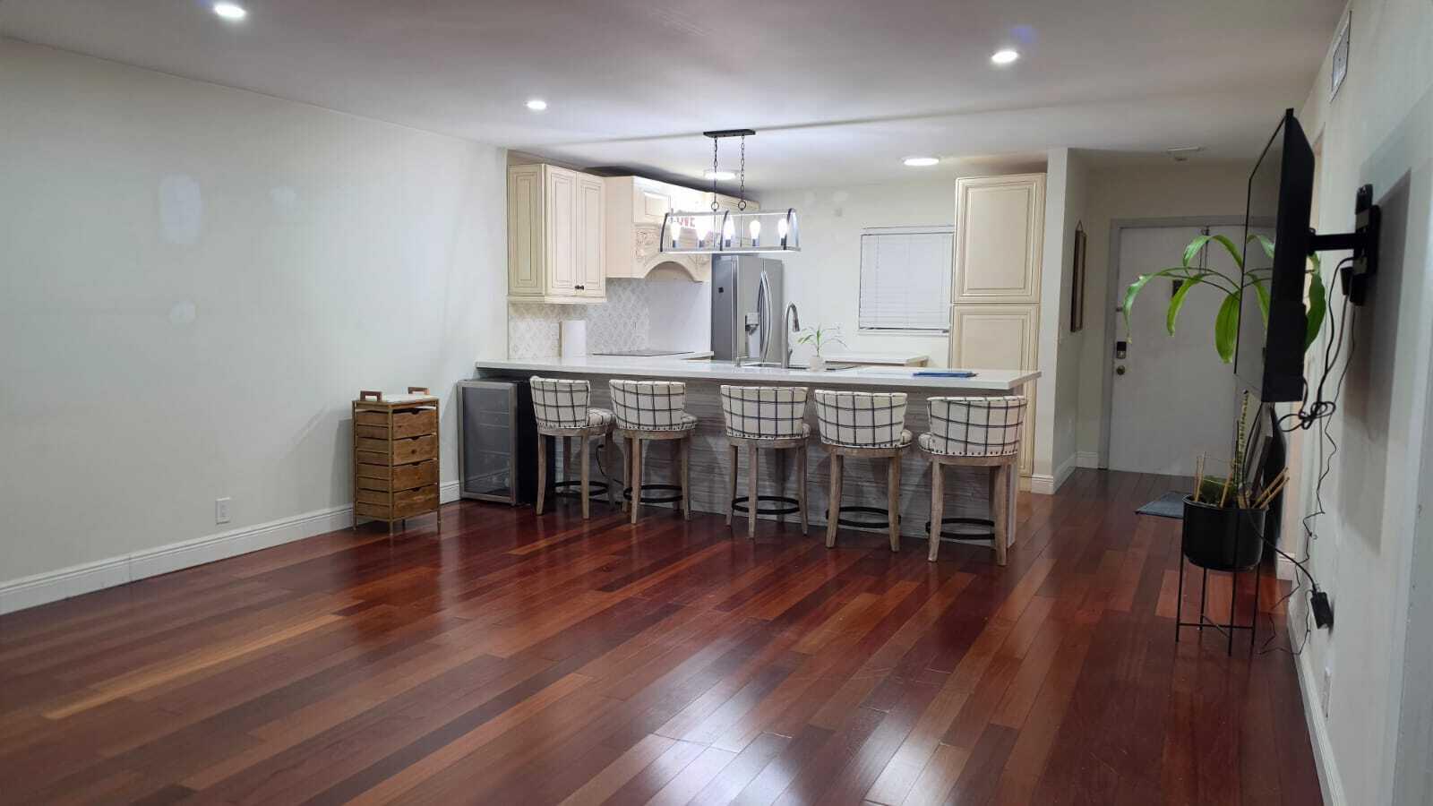100 Ashbury Road, Unit 206 Hollywood, FL 33024 - Photo 11 of 23 a kitchen with stainless steel appliances a dining table chairs and wooden floor
