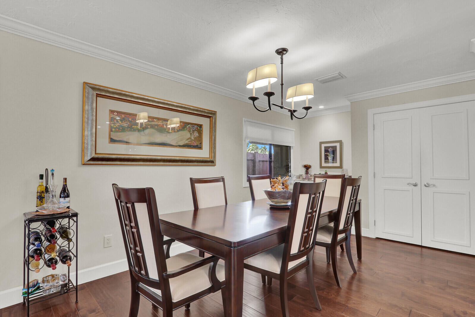 3060 Southeast Darien Road Port St. Lucie, FL 34952 - Photo 16 of 56 a view of a dining room with furniture wooden floor and a chandelier