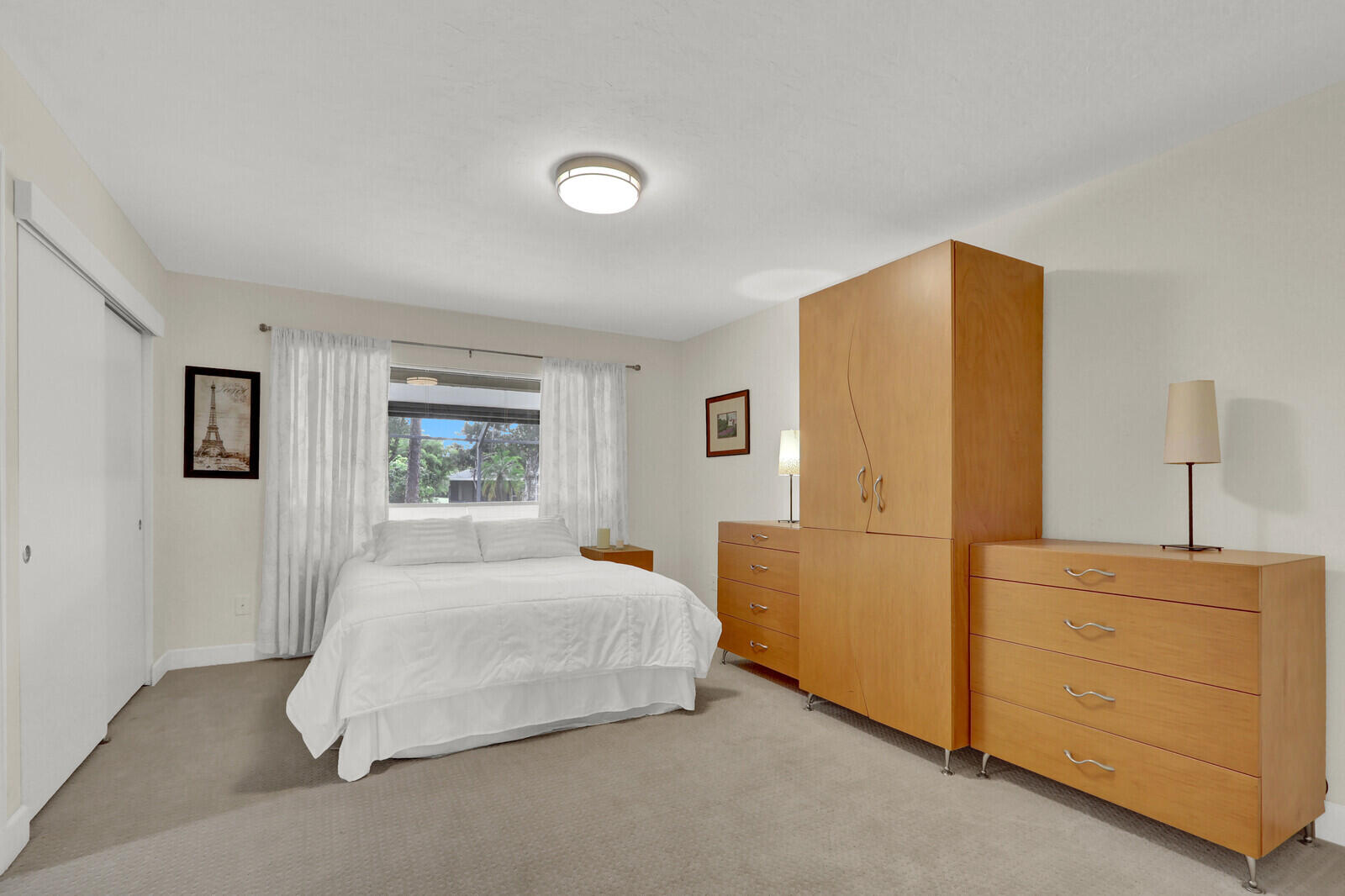 3060 Southeast Darien Road Port St. Lucie, FL 34952 - Photo 17 of 56 a bedroom with a bed and a dresser