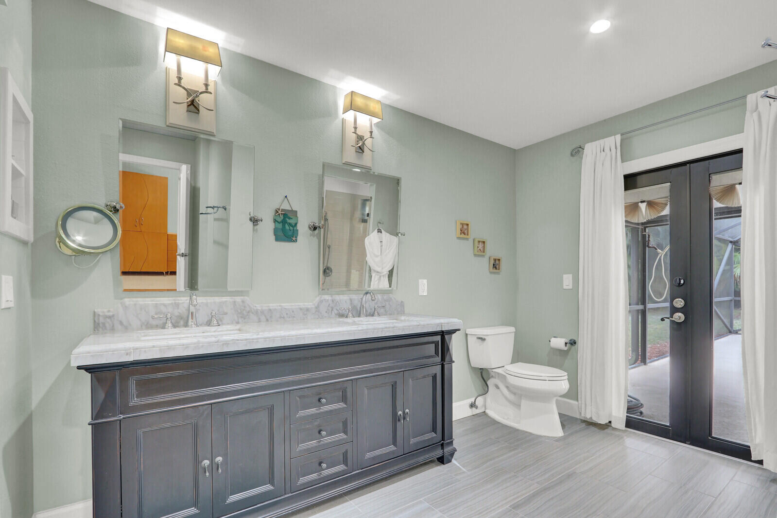3060 Southeast Darien Road Port St. Lucie, FL 34952 - Photo 20 of 56 a spacious bathroom with a granite countertop sink toilet a large mirror a vanity and shower