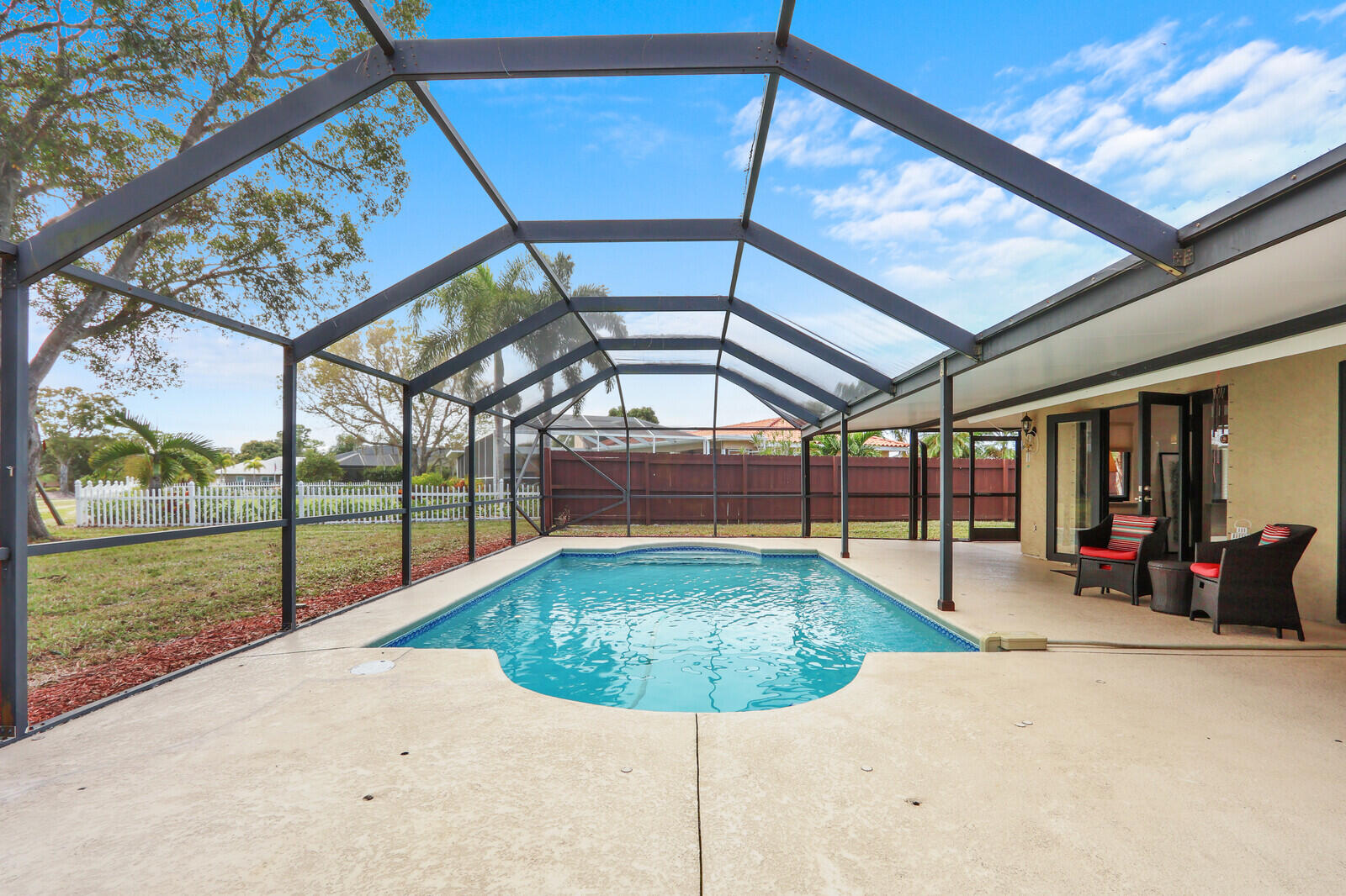 3060 Southeast Darien Road Port St. Lucie, FL 34952 - Photo 42 of 56 a view of a swimming pool with an outdoor seating